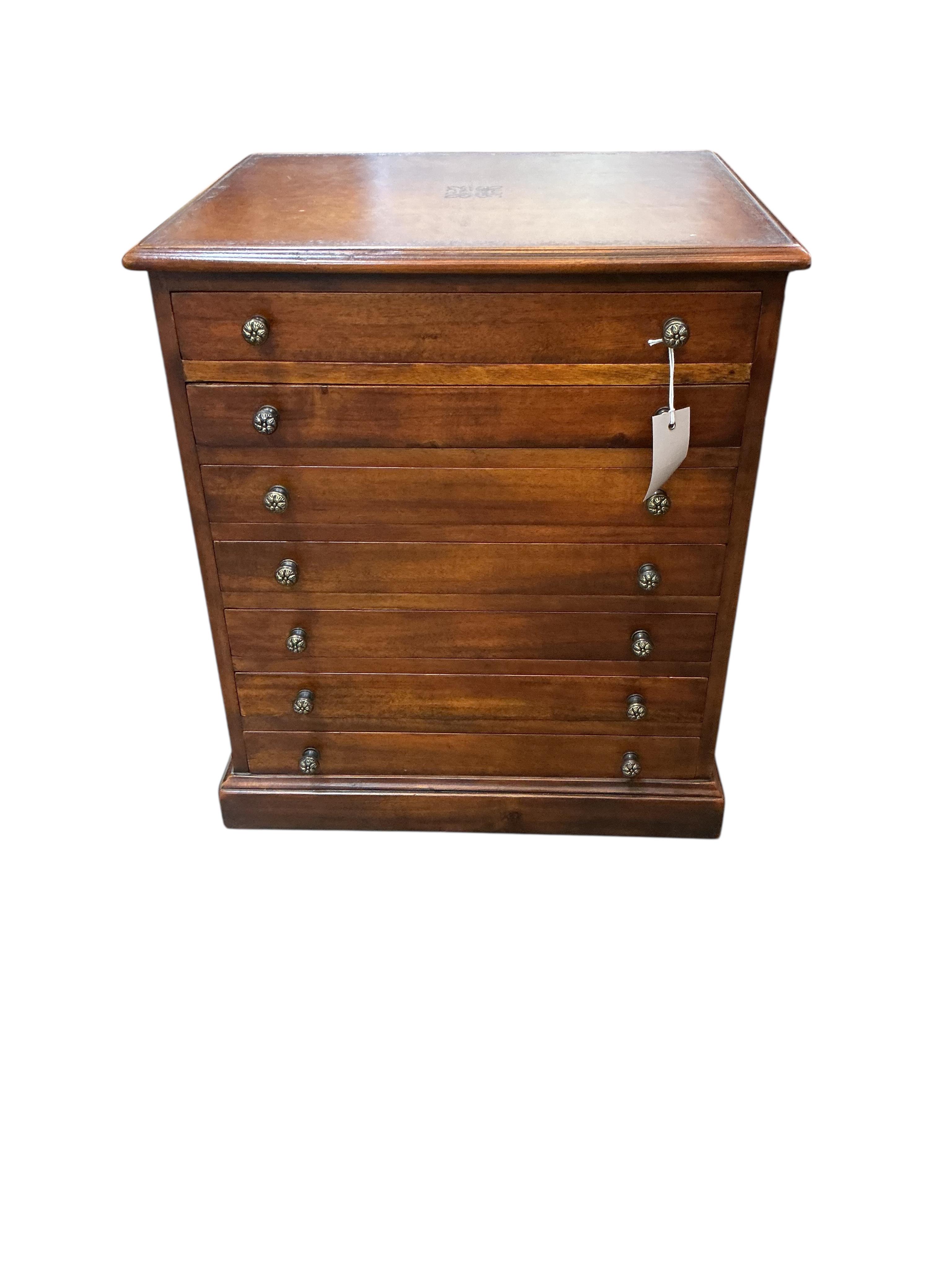 A reproduction mahogany seven drawer collector's chest with leather inset top, width 48cm, depth 40cm, height 56cm